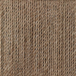 A steel dining chair frame is softened and paired with natural woven fibers. Thin, tapered legs and a tall channeled back cre