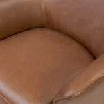 Smooth lines and impeccable tailoring bring a clean, elevated look to this modernized 360 swivel chair. Made from top-grain leather with a rich mahogany finish, flared arms and piping trim reflect the intention behind this timeless design Amethyst Home provides interior design, new home construction design consulting, vintage area rugs, and lighting in the Newport Beach metro area.