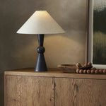 Polished forms define this sculptural table lamp, featuring a base of black Italian marble with distinctive white veining and a tapered flax linen shade Amethyst Home provides interior design, new home construction design consulting, vintage area rugs, and lighting in the Portland metro area.