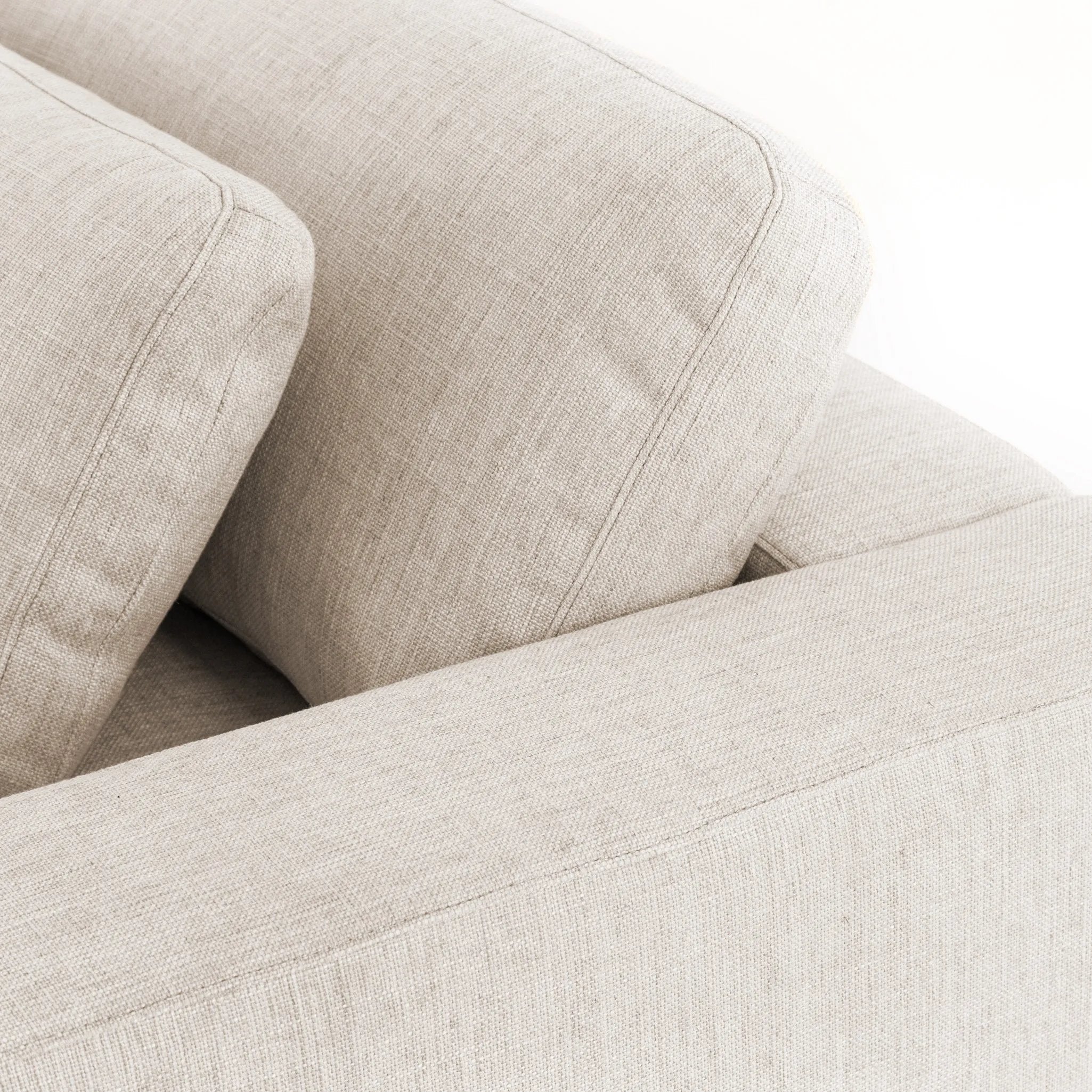 Deep, modern and seductive. This dramatic, spacious sofa is covered in a durable light neutral woven fabric that mixes well with any color palette Amethyst Home provides interior design, new home construction design consulting, vintage area rugs, and lighting in the Nashville metro area.
