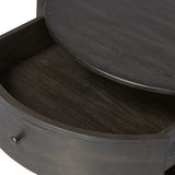 Rich contours bring character to the bedside. A round black-finished oak table has a spacious cubby and a single drawer with metal glides and a bronzed pull Amethyst Home provides interior design, new home construction design consulting, vintage area rugs, and lighting in the Los Angeles metro area.