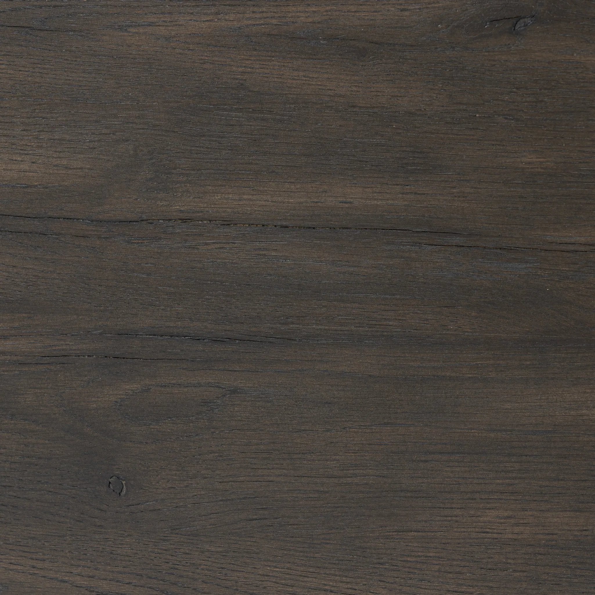 Rich contours bring character to the bedside. A round black-finished oak table has a spacious cubby and a single drawer with metal glides and a bronzed pull Amethyst Home provides interior design, new home construction design consulting, vintage area rugs, and lighting in the Monterey metro area.