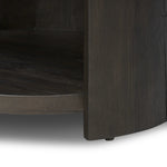 Rich contours bring character to the bedside. A round black-finished oak table has a spacious cubby and a single drawer with metal glides and a bronzed pull Amethyst Home provides interior design, new home construction design consulting, vintage area rugs, and lighting in the Seattle metro area.