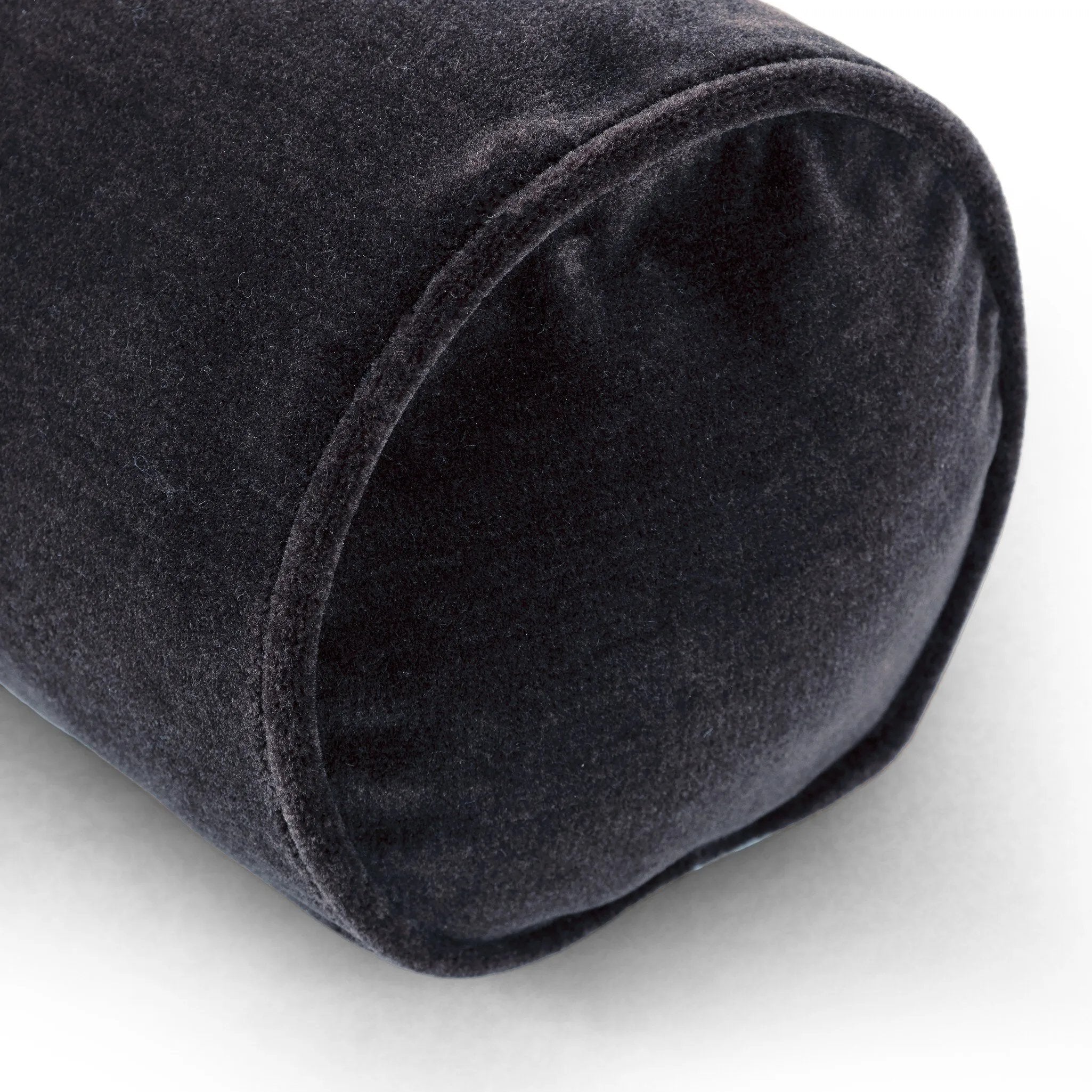 A long, navy-colored bolster pillow elevates beds and sofas in an instant. Crafted from saturated wool velvet, for a sustainable alternative to mohair, with a hidden zipper for a smooth silhouette.As lovers of wabi sabi aesthetics at Amethyst, we love the warm modern inspired Bridger Bolster Pillow - Monte Navy. Amethyst Home provides interior design, new home construction design consulting, vintage area rugs, and lighting in the Los Angeles metro area.