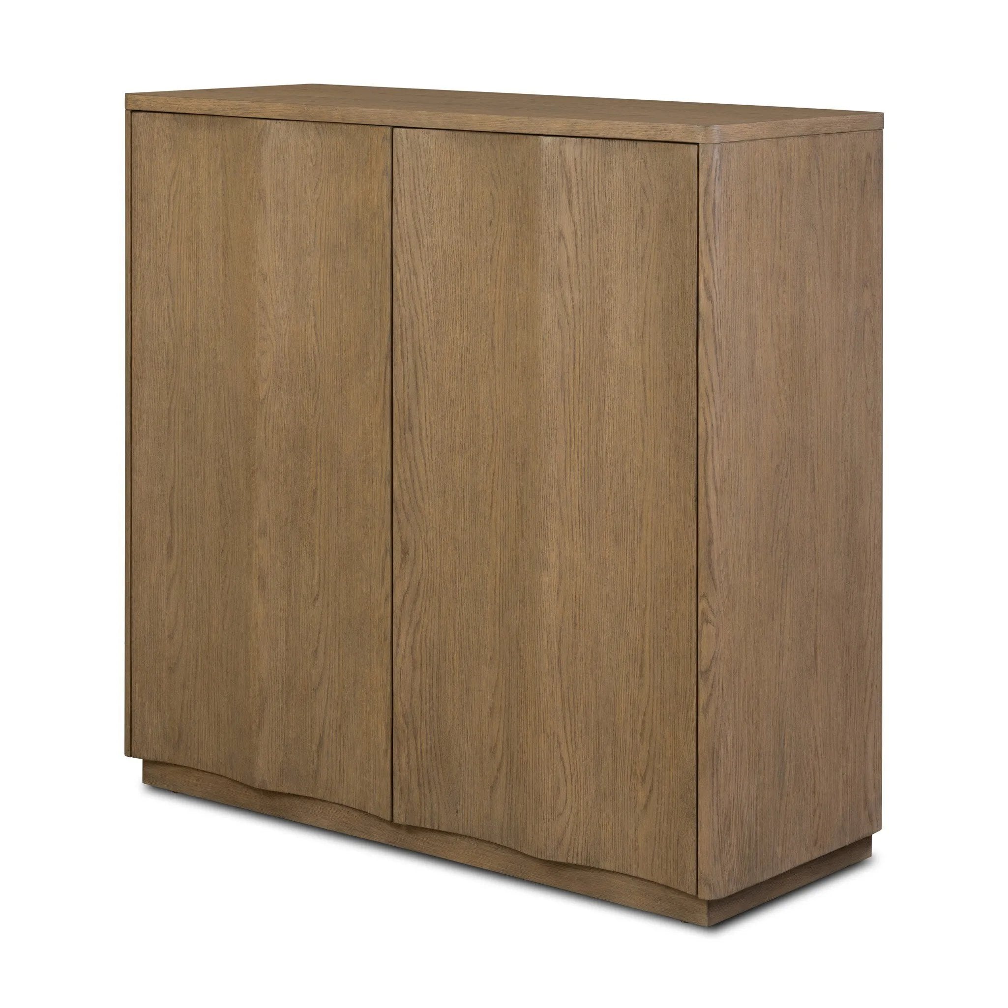 The classic wooden cabinet, reimagined. This warm oak piece features double doors with shallow scalloping that draws the eye, providing a subtle visual flow.As lovers of wabi sabi design at Amethyst, we love the designer inspired Brookhurst Small Cabinet - Drifted Oak Veneer. Amethyst Home provides interior design, new home construction design consulting, vintage area rugs, and lighting in the Portland metro area.