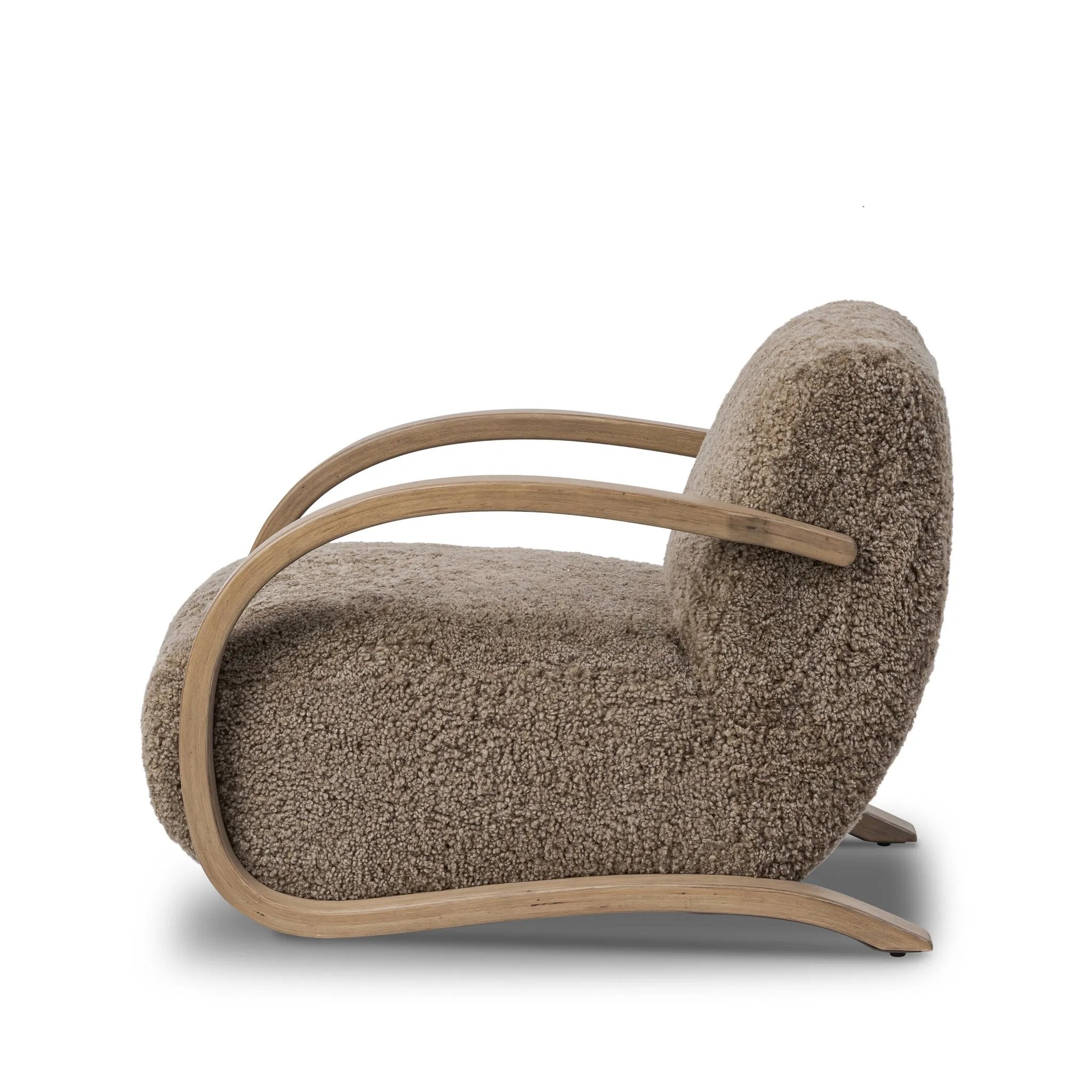 Soft texture and eye-catching contours fuse in this comfort-driven accent chair, pairing a low, luxurious shearling seat and dramatic bent wood frame Amethyst Home provides interior design, new home construction design consulting, vintage area rugs, and lighting in the Portland metro area.