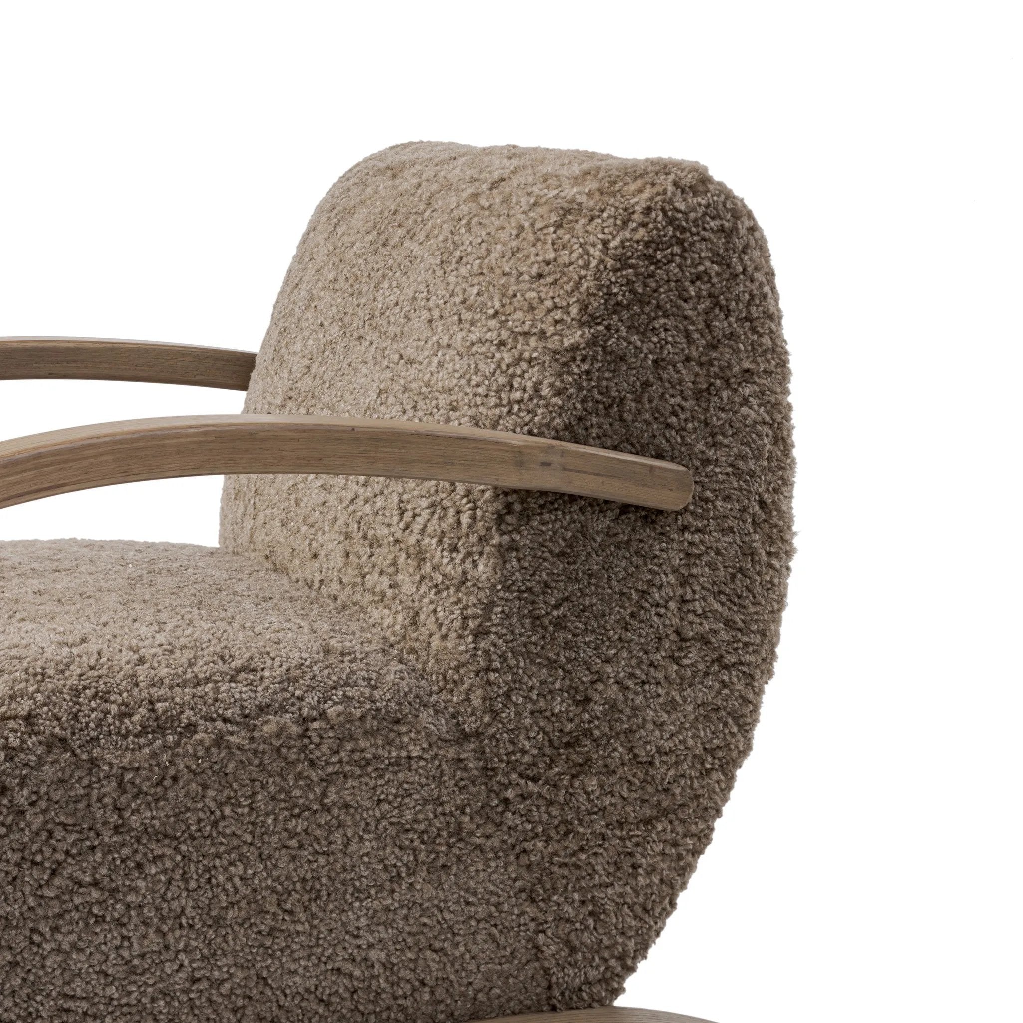 Soft texture and eye-catching contours fuse in this comfort-driven accent chair, pairing a low, luxurious shearling seat and dramatic bent wood frame Amethyst Home provides interior design, new home construction design consulting, vintage area rugs, and lighting in the Seattle metro area.