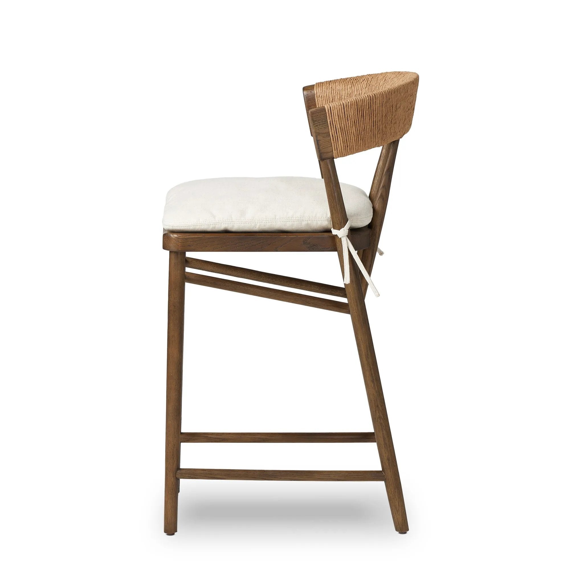 A solid oak counter stool defined by tapered legs and framing gives an updated look to the classic whistler chair. Finished with a paper rush wrapped detail on the back Amethyst Home provides interior design, new home construction design consulting, vintage area rugs, and lighting in the Nashville metro area.
