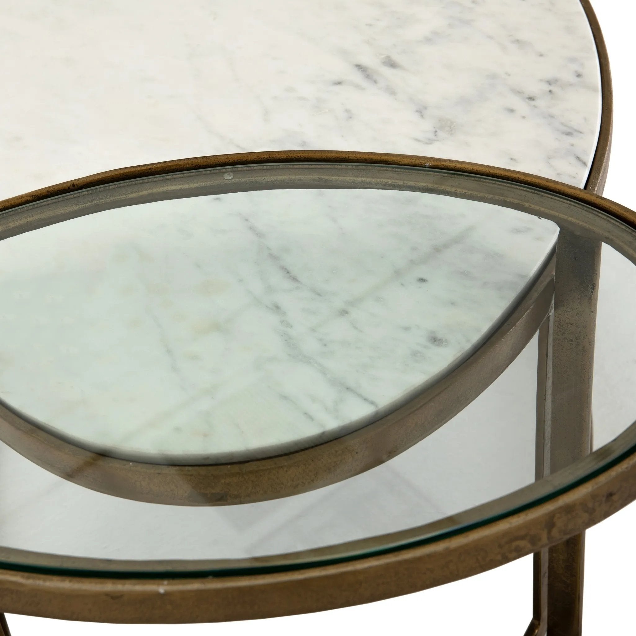 Featuring Calder Polished White Marble Nesting Coffee Table by Four Hands at Amethyst Home. Shapely surfaces, designed to slide together or apart with ease. A raw brass finish lends a lived-in feel to aluminum framing, with one oval-shaped nester topped by polished white marble pairing with a taller, rounded table featuring tempered glass.    Large Table: . Amethyst Home provides interior design, new home construction design consulting, vintage area rugs, and lighting in the Alpharetta metro area.