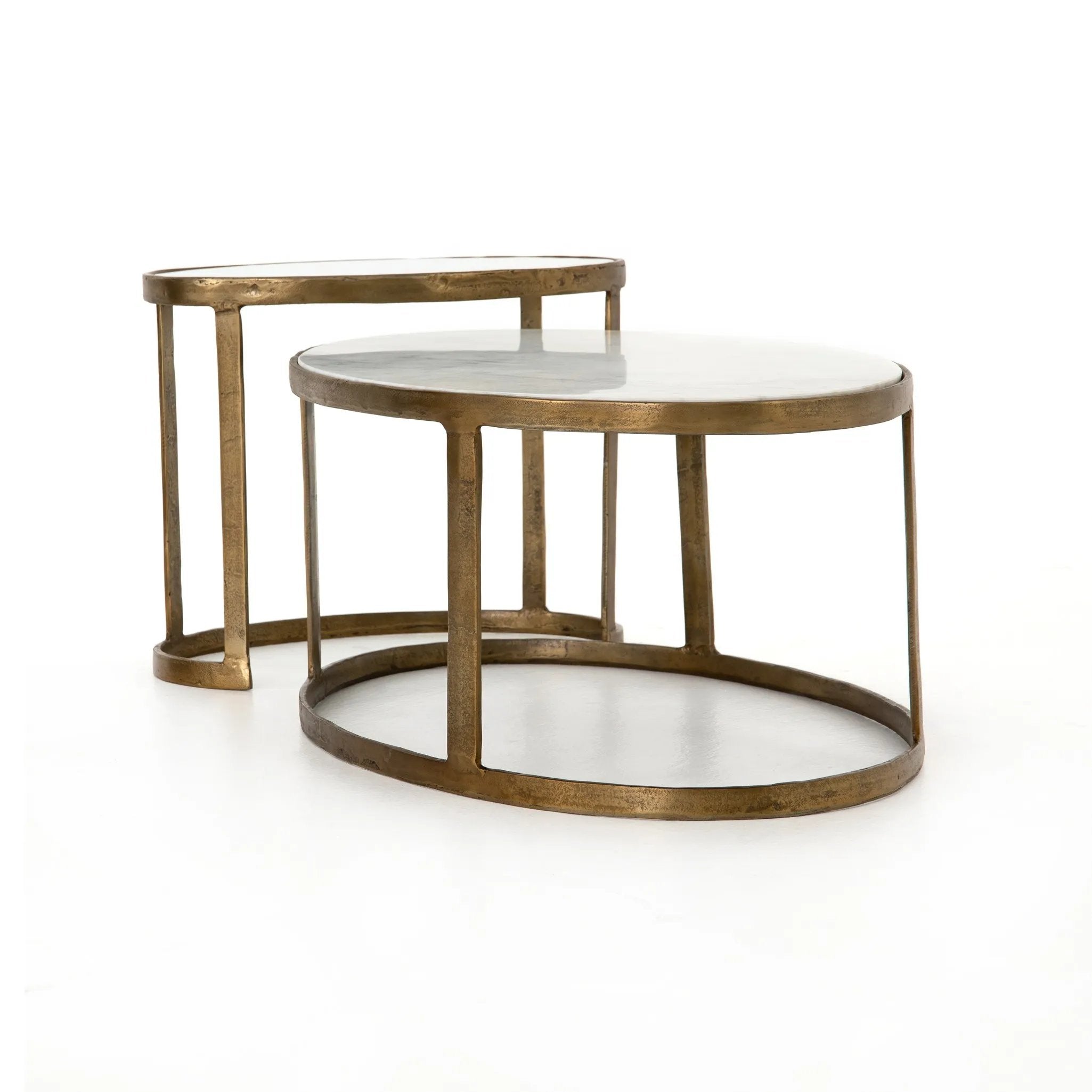 Featuring Calder Polished White Marble Nesting Coffee Table by Four Hands at Amethyst Home. Shapely surfaces, designed to slide together or apart with ease. A raw brass finish lends a lived-in feel to aluminum framing, with one oval-shaped nester topped by polished white marble pairing with a taller, rounded table featuring tempered glass.    Large Table: 3. Amethyst Home provides interior design, new home construction design consulting, vintage area rugs, and lighting in the Calabasas metro area.
