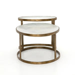 Featuring Calder Polished White Marble Nesting Coffee Table by Four Hands at Amethyst Home. Shapely surfaces, designed to slide together or apart with ease. A raw brass finish lends a lived-in feel to aluminum framing, with one oval-shaped nester topped by polished white marble pairing with a taller, rounded table featuring tempered glass.    Large Table: 3. Amethyst Home provides interior design, new home construction design consulting, vintage area rugs, and lighting in the Nashville metro area.
