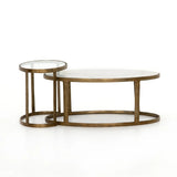 Featuring Calder Polished White Marble Nesting Coffee Table by Four Hands at Amethyst Home. Shapely surfaces, designed to slide together or apart with ease. A raw brass finish lends a lived-in feel to aluminum framing, with one oval-shaped nester topped by polished white marble pairing with a taller, rounded table featuring tempered glass.    Large Table: 38.00. Amethyst Home provides interior design, new home construction design consulting, vintage area rugs, and lighting in the Tampa metro area.