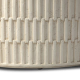 Cast concrete shapes a drum-style outdoor coffee table, with a linear pattern layered for added texture. Finished with a parchment-like textural feel. Cover or store inside during inclement weather and when not in use.As lovers of wabi sabi design at Amethyst, we love the warm modern inspired Callisto Outdoor Coffee Table - Aged White Concrete. Amethyst Home provides interior design, new home construction design consulting, vintage area rugs, and lighting in the Laguna Beach metro area.