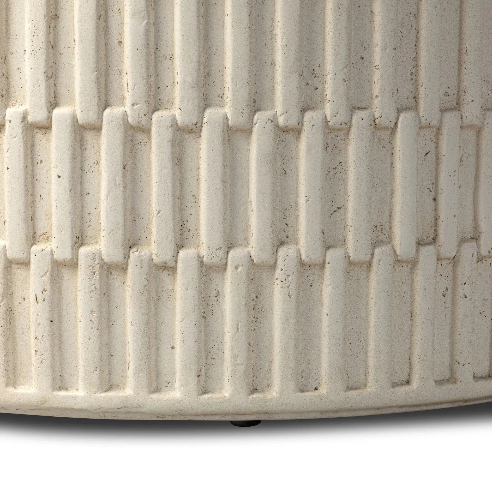 Cast concrete shapes a drum-style outdoor coffee table, with a linear pattern layered for added texture. Finished with a parchment-like textural feel. Cover or store inside during inclement weather and when not in use.As lovers of wabi sabi design at Amethyst, we love the warm modern inspired Callisto Outdoor Coffee Table - Aged White Concrete. Amethyst Home provides interior design, new home construction design consulting, vintage area rugs, and lighting in the Laguna Beach metro area.
