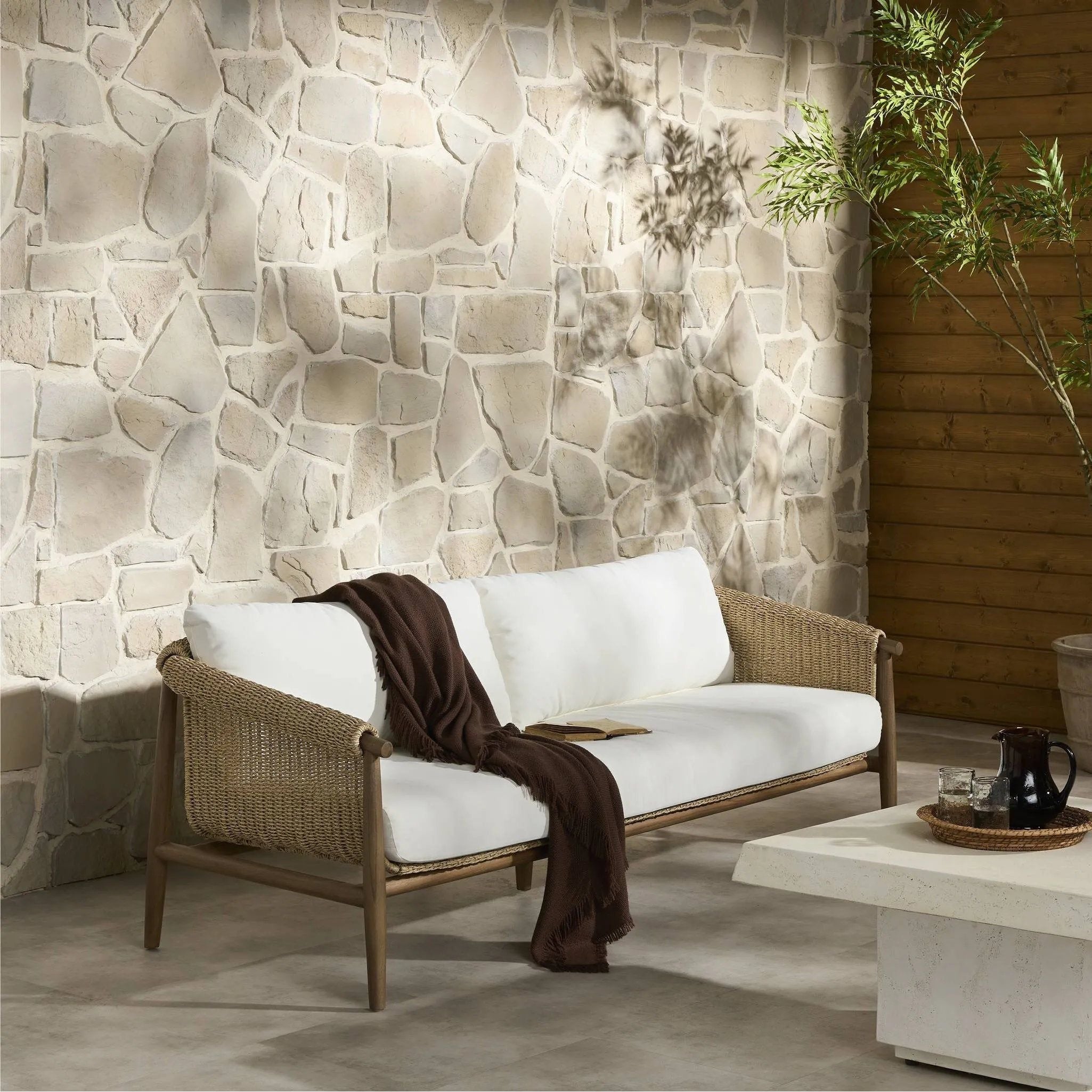 Bring home vintage inspiration. The sling shape of this outdoor sofa features a reimagined bucket seat in woven faux hyacinth, finished with rounded tapered legs that mirror the shape of the frame. Cover or store indoors during inclement weather and when not in use Amethyst Home provides interior design, new home construction design consulting, vintage area rugs, and lighting in the Calabasas metro area.