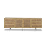 Featuring Carmel Natural Cane Sideboard 96" by Four Hands at Amethyst Home. Midcentury-inspired style with an organic twist. Surrounded by mango casing, light cane weaves for a fresh, natural look. Finished off with angular gunmetal-finished iron legs. Plenty of interior storage for your favorite table linens and dinnerware. Overall Dimensions: 96.00"w x 18.00. Amethyst Home provides interior design, new home construction design consulting, vintage area rugs, and lighting in the Dallas metro area.