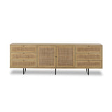 Featuring Carmel Natural Cane Sideboard 96" by Four Hands at Amethyst Home. Midcentury-inspired style with an organic twist. Surrounded by mango casing, light cane weaves for a fresh, natural look. Finished off with angular gunmetal-finished iron legs. Plenty of interior storage for your favorite table linens and dinnerware. Overall Dimensions: 96.00"w x 18.00. Amethyst Home provides interior design, new home construction design consulting, vintage area rugs, and lighting in the Dallas metro area.