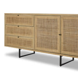 Featuring Carmel Natural Cane Sideboard 96" by Four Hands at Amethyst Home. Midcentury-inspired style with an organic twist. Surrounded by mango casing, light cane weaves for a fresh, natural look. Finished off with angular gunmetal-finished iron legs. Plenty of interior storage for your favorite table linens and dinnerware. Overall Dimensions: 96.00"w x 18.00". Amethyst Home provides interior design, new home construction design consulting, vintage area rugs, and lighting in the Omaha metro area.