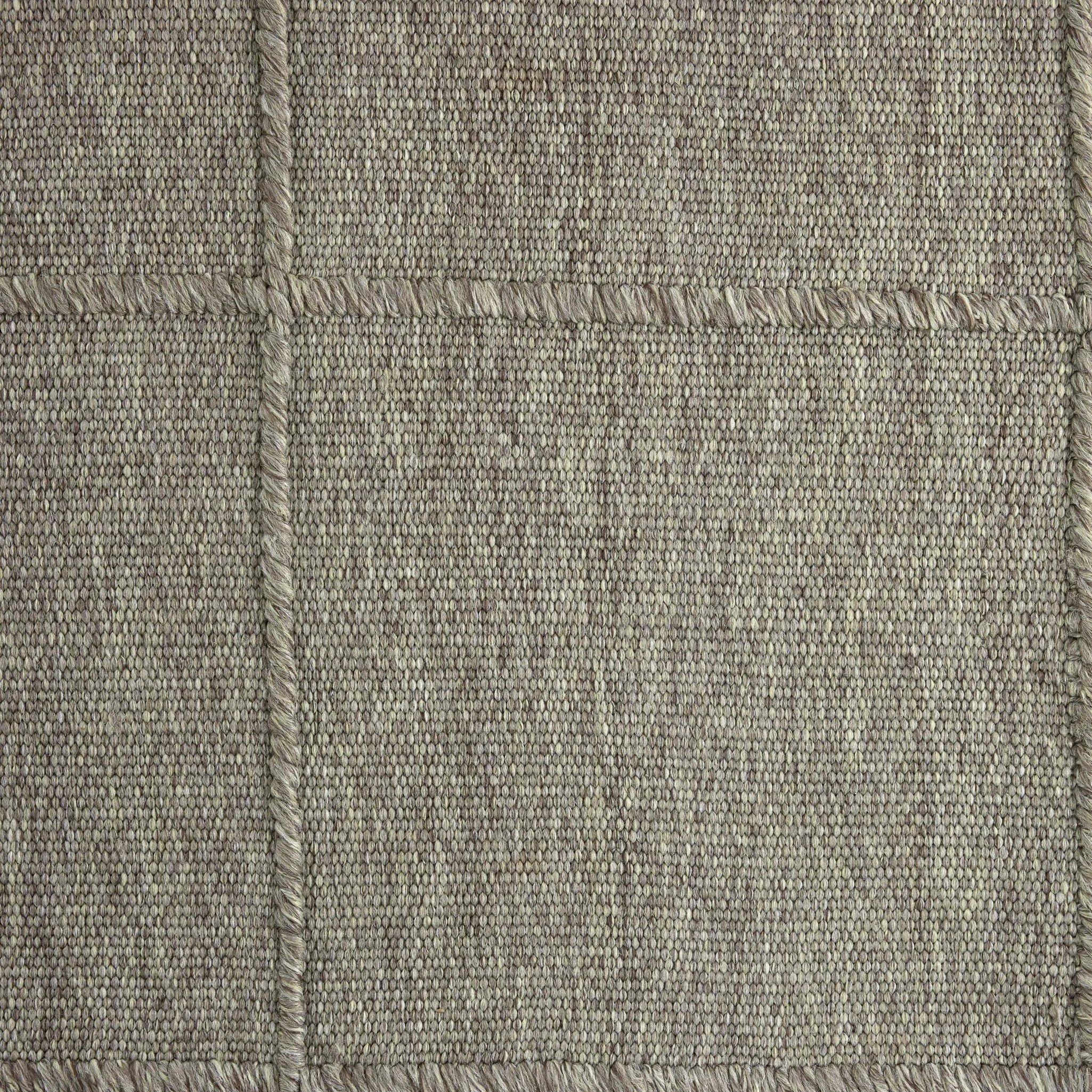 Hand woven in a flat weave grid pattern for the look of an indoor textile, this  silver-hued rug grounds the outdoor lounge with a high-texture look. Slight variation in sizing and imperfect lines due to the handcrafted nature of each piece are to be expected. Store inside during inclement weather and when not in use. Amethyst Home provides interior design, new home construction design consulting, vintage area rugs, and lighting in the Houston metro area.
