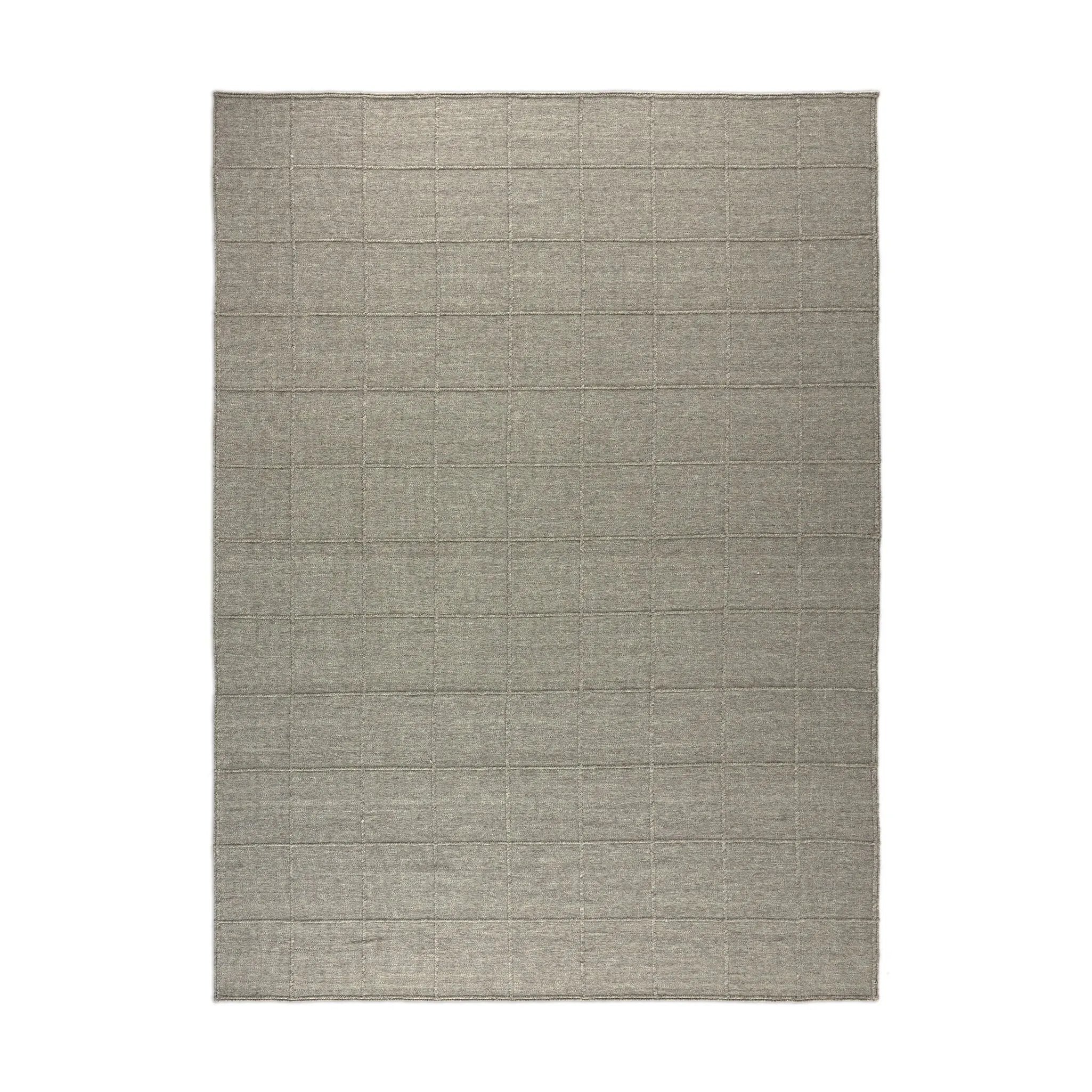 Hand woven in a flat weave grid pattern for the look of an indoor textile, this  silver-hued rug grounds the outdoor lounge with a high-texture look. Slight variation in sizing and imperfect lines due to the handcrafted nature of each piece are to be expected. Store inside during inclement weather and when not in use. Amethyst Home provides interior design, new home construction design consulting, vintage area rugs, and lighting in the Newport Beach metro area.