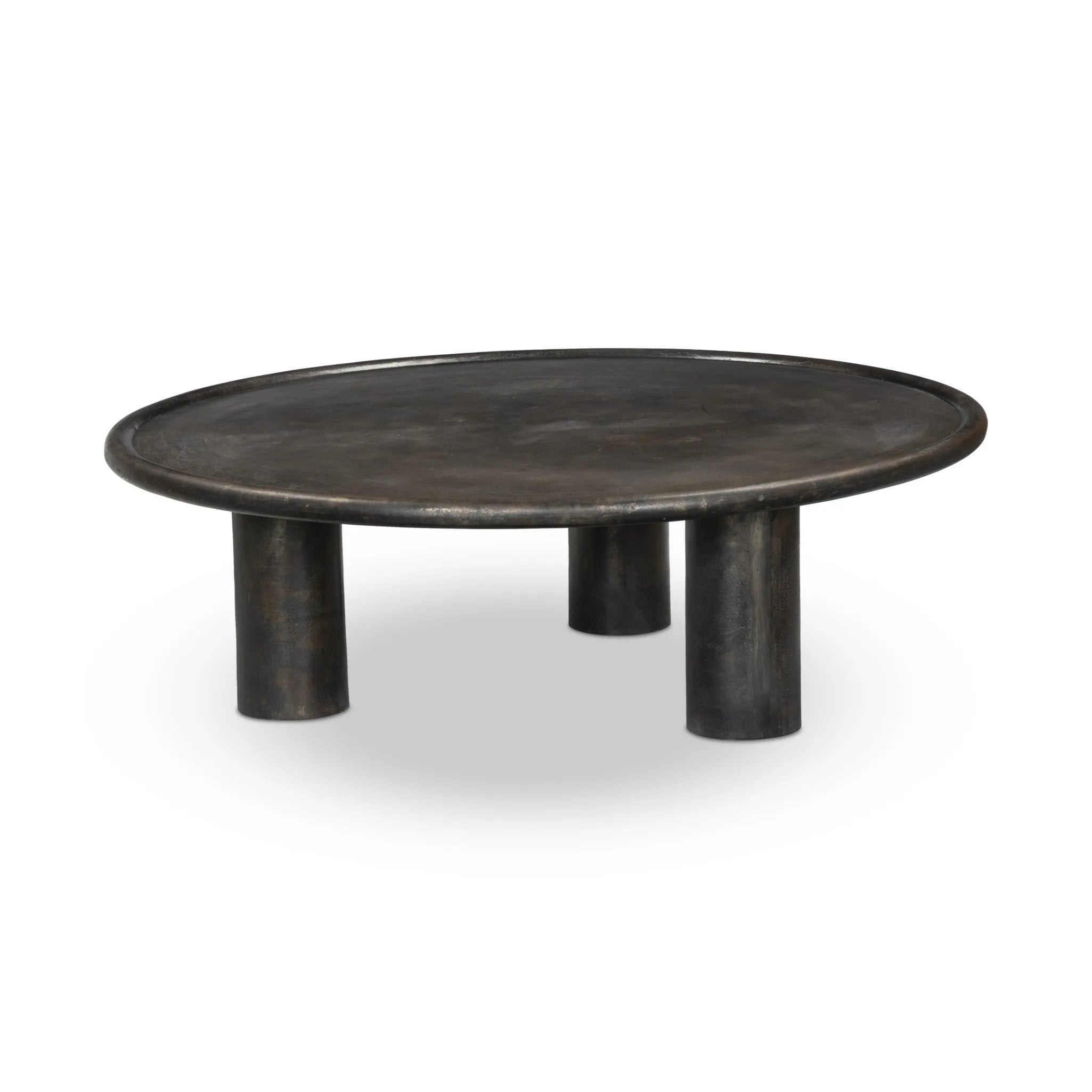A round, three-legged coffee table of cast aluminum is finished in a beautiful distressed bronze. The result: a luxe take on industrial that moves between spaces and styles with ease Amethyst Home provides interior design, new home construction design consulting, vintage area rugs, and lighting in the Des Moines metro area.