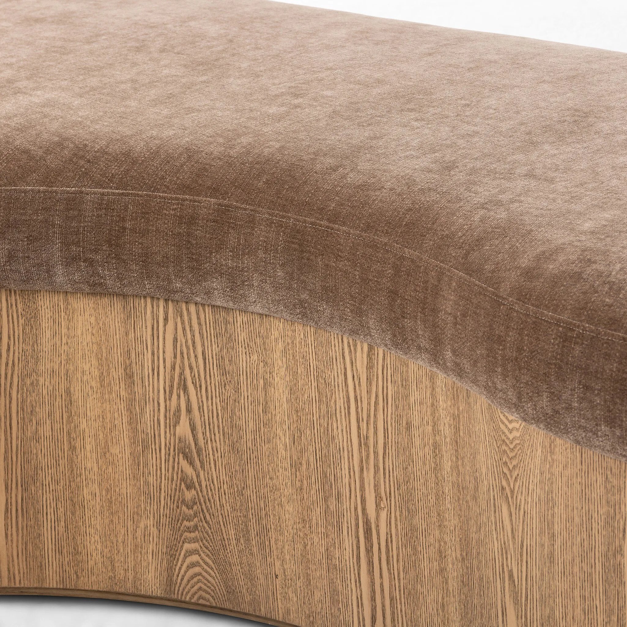 Elevate any room with a curvy statement bench. Made from a kidney-shaped base of toasted ash veneer and a soft, velvety seat Amethyst Home provides interior design, new home construction design consulting, vintage area rugs, and lighting in the Austin metro area.
