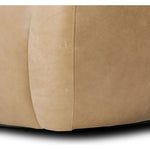 Meet modern comfort. Clean curves, impeccable tailoring and taupe top-grain leather with a pronounced grain bring an elevated, European-inspired look to this swivel chair Amethyst Home provides interior design, new home construction design consulting, vintage area rugs, and lighting in the Austin metro area.
