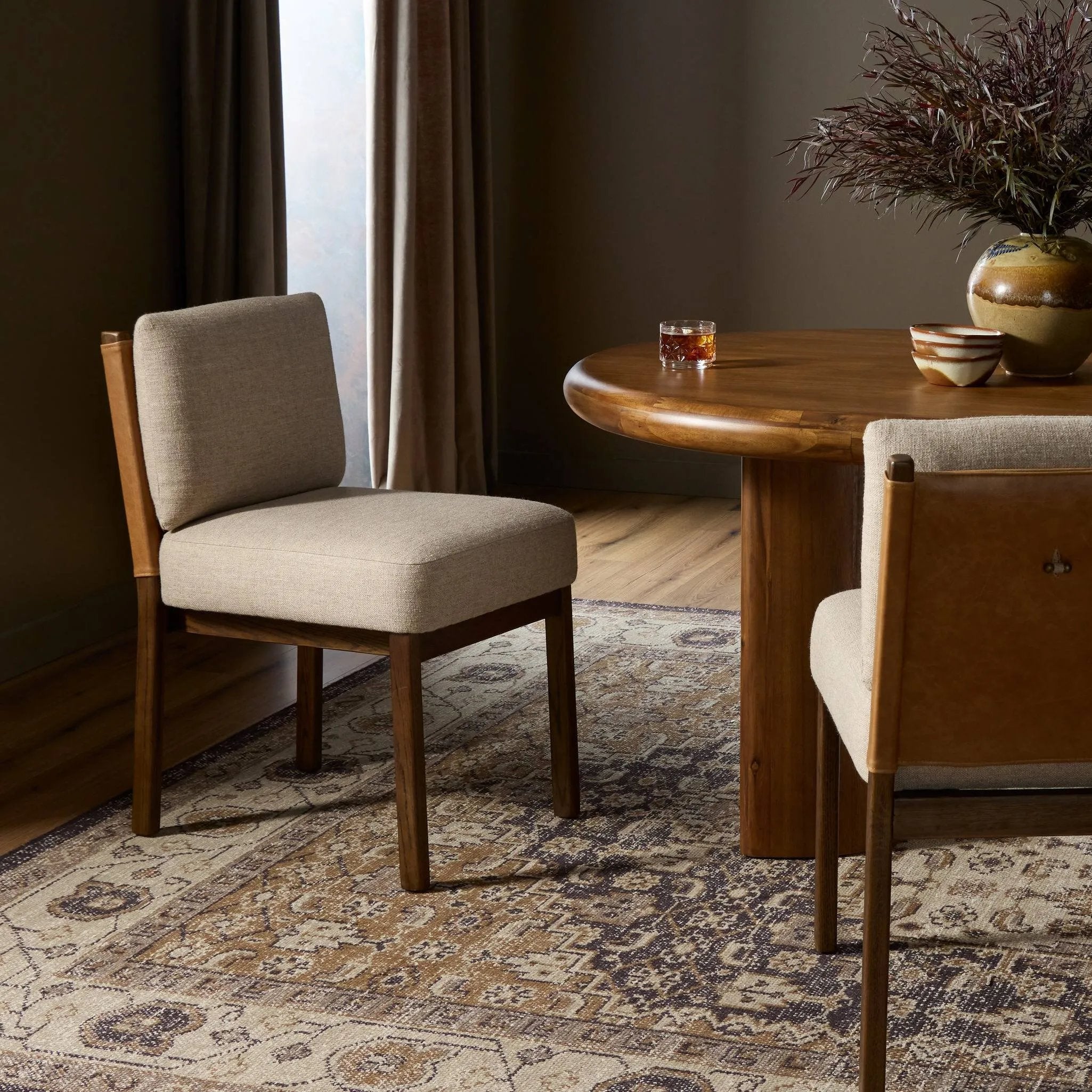 Featuring Chappel Alcala Taupe Dining Chair by Four Hands at Amethyst Home. Elevate your dining space with a mixed-material dining chair of solid oak, top-grain leather and high-performance fabric. On the back, small iron detailing completes the look. Overall Dimensions: 21.00"w x 26.00"d x 33.00"h. Amethyst Home provides interior design, new home construction design consulting, vintage area rugs, and lighting in the Omaha metro area.