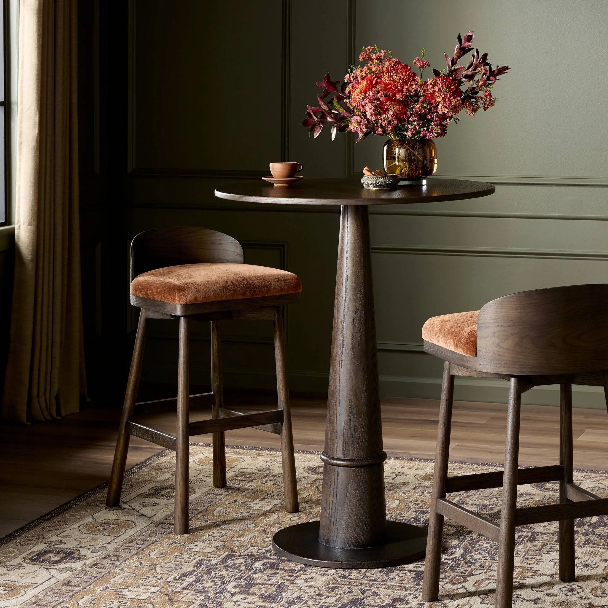 Featuring Cloris Altair Sienna Swivel Bar + Counter Stool by Four Hands at Amethyst Home. Channel vintage vibes with a swivel stool perfectly sized for the bar. Crafted of dark-finished oak, a low, molded back adds a playful touch, while an upholstered seat offers comfort and color. Finished off with a memory swivel to ensure the stool's curved wood back stays . Amethyst Home provides interior design, new home construction design consulting, vintage area rugs, and lighting in the Omaha metro area.