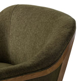 A Swedish Gustavian inspired captain chair gets a modern update with high arms and an exposed frame. The tight cushion in olive fabric paired with buff parawood lends a luxe natural feel Amethyst Home provides interior design, new home construction design consulting, vintage area rugs, and lighting in the Calabasas metro area.