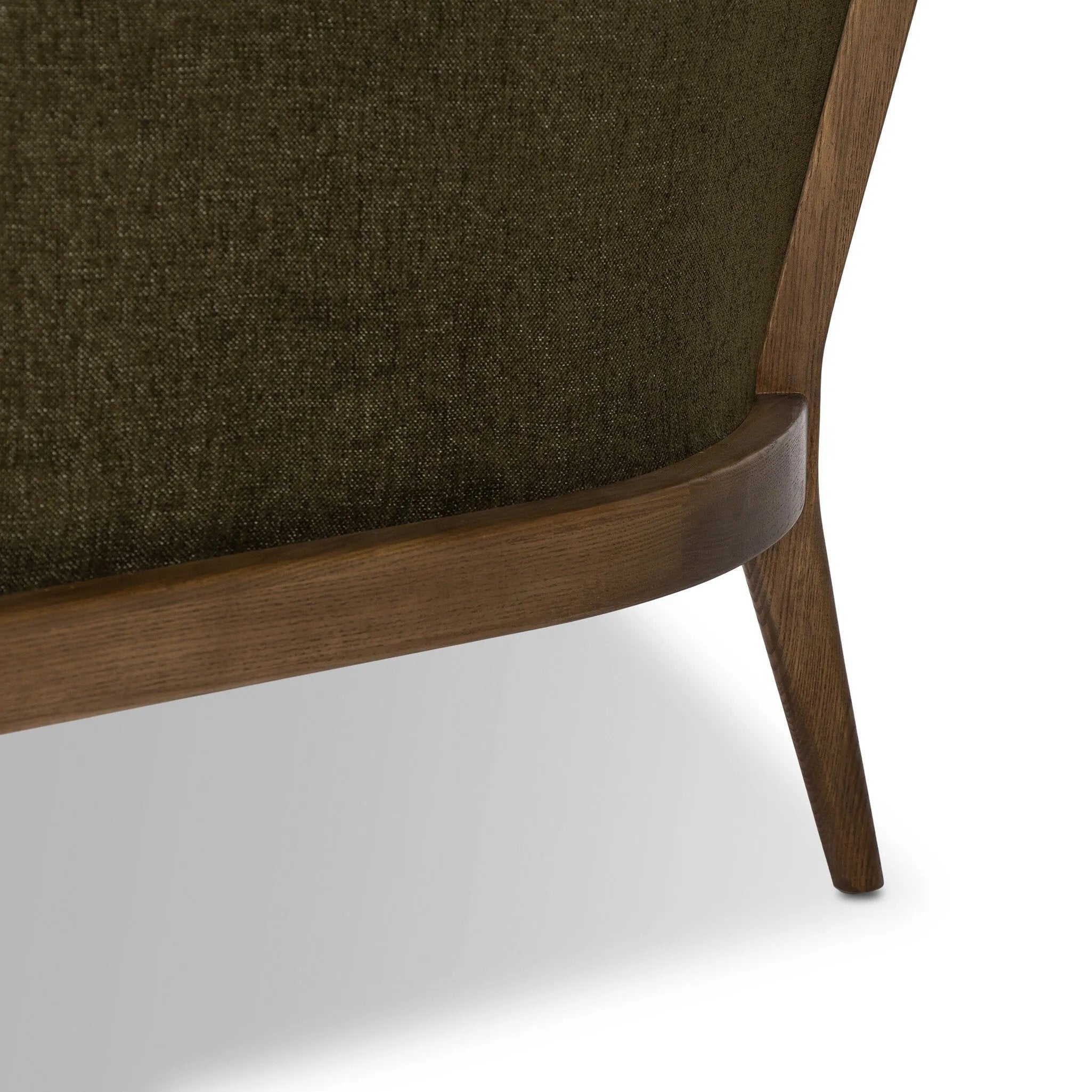 A Swedish Gustavian inspired captain chair gets a modern update with high arms and an exposed frame. The tight cushion in olive fabric paired with buff parawood lends a luxe natural feel Amethyst Home provides interior design, new home construction design consulting, vintage area rugs, and lighting in the Omaha metro area.