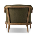 A Swedish Gustavian inspired captain chair gets a modern update with high arms and an exposed frame. The tight cushion in olive fabric paired with buff parawood lends a luxe natural feel Amethyst Home provides interior design, new home construction design consulting, vintage area rugs, and lighting in the Seattle metro area.