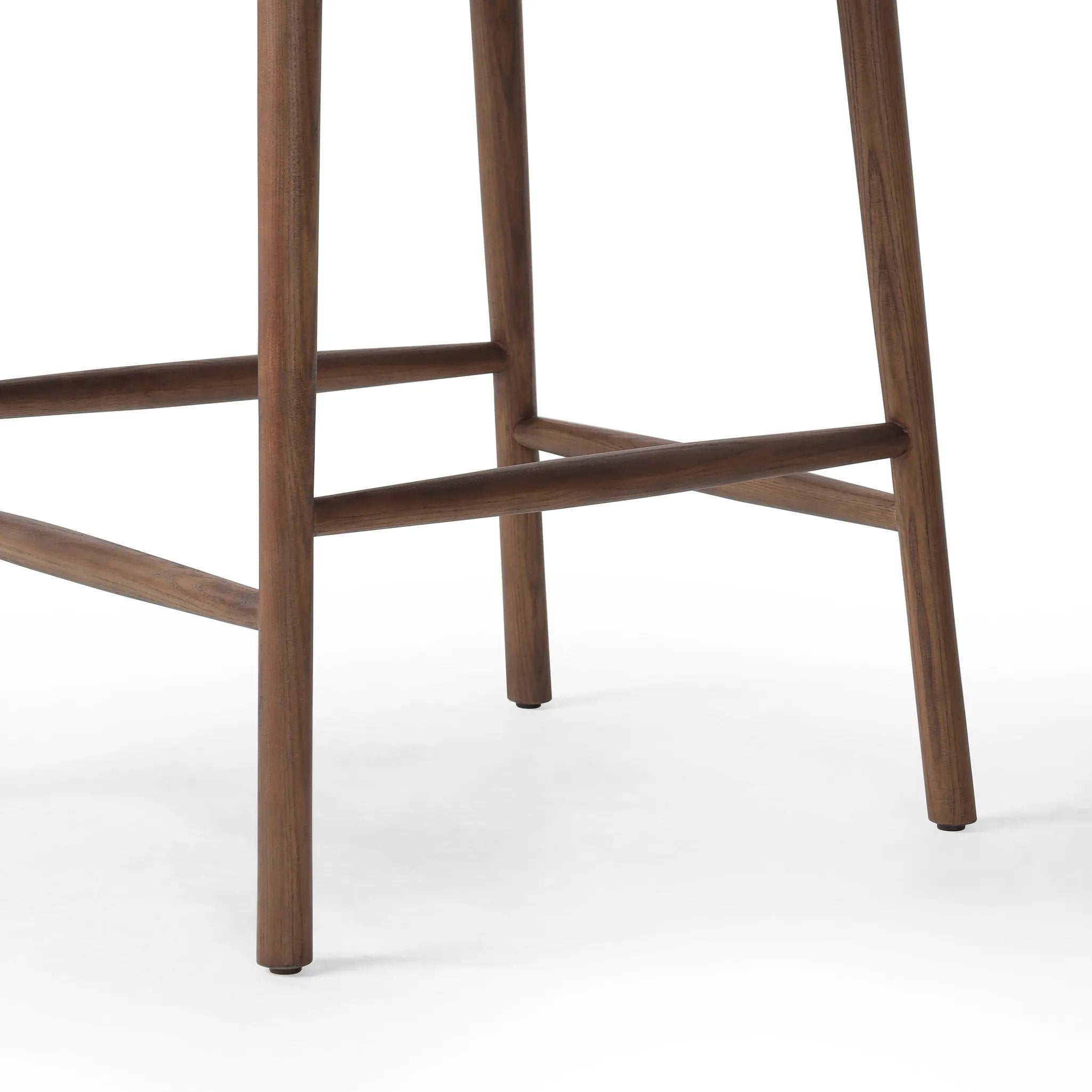 Made from solid ash with a vintage finish, this versatile counter stool pairs an airy back with tapered spindles, for a simple, inviting look. A fixed upholstered seat of top-grain leather adds a smart, comfortable touch Amethyst Home provides interior design, new home construction design consulting, vintage area rugs, and lighting in the Charlotte metro area.