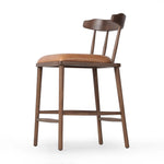 Made from solid ash with a vintage finish, this versatile counter stool pairs an airy back with tapered spindles, for a simple, inviting look. A fixed upholstered seat of top-grain leather adds a smart, comfortable touch Amethyst Home provides interior design, new home construction design consulting, vintage area rugs, and lighting in the Miami metro area.