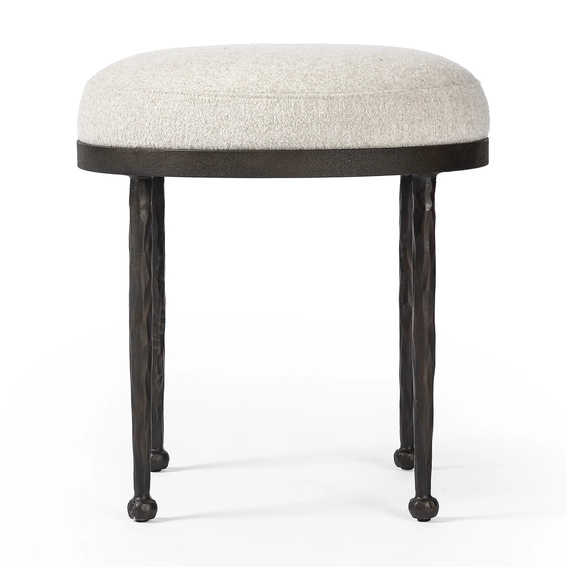 Work midcentury vibes into any space with a pared-back accent stool that doubles as a cocktail ottoman. Wrough iron legs finished in a hammered bronze pair with a simple rounded seat upholstered in a texture-rich fabric, with S-spring suspension for comfort and structure Amethyst Home provides interior design, new home construction design consulting, vintage area rugs, and lighting in the Omaha metro area.