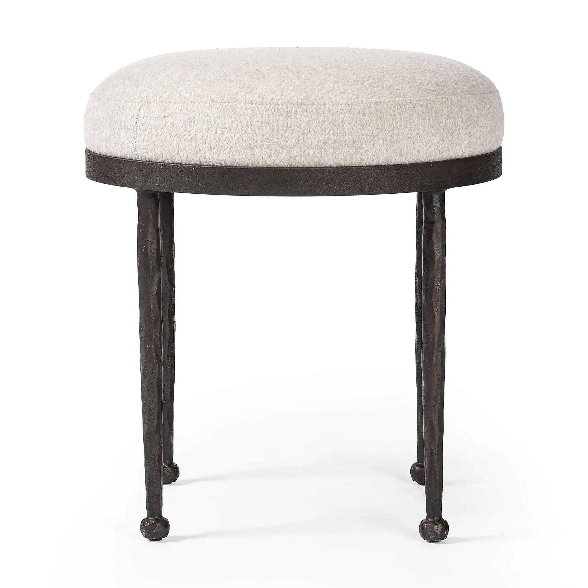Work midcentury vibes into any space with a pared-back accent stool that doubles as a cocktail ottoman. Wrough iron legs finished in a hammered bronze pair with a simple rounded seat upholstered in a texture-rich fabric, with S-spring suspension for comfort and structure Amethyst Home provides interior design, new home construction design consulting, vintage area rugs, and lighting in the Park City metro area.
