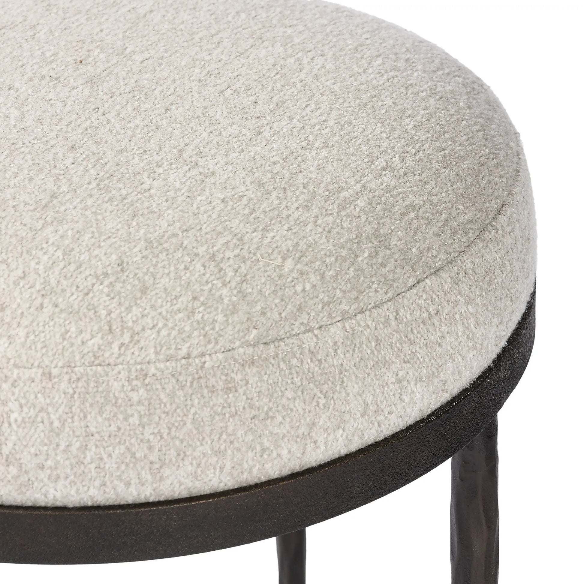 Work midcentury vibes into any space with a pared-back accent stool that doubles as a cocktail ottoman. Wrough iron legs finished in a hammered bronze pair with a simple rounded seat upholstered in a texture-rich fabric, with S-spring suspension for comfort and structure Amethyst Home provides interior design, new home construction design consulting, vintage area rugs, and lighting in the San Diego metro area.