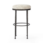 Featuring Corinne Ivan Stone Bar + Counter Stool by Four Hands at Amethyst Home. Hammered bronze legs with ball-shaped foot details elevate this simply shaped counter stool. A round, cushioned seat in a heavy boucle-like fabric finishes this counter-height stool's clean, inviting look.BarOverall Dimensions: 17.00"w x 17.00"d x 31.25"hWeight: 32.19 lbsCoun. Amethyst Home provides interior design, new home construction design consulting, vintage area rugs, and lighting in the Los Angeles metro area.