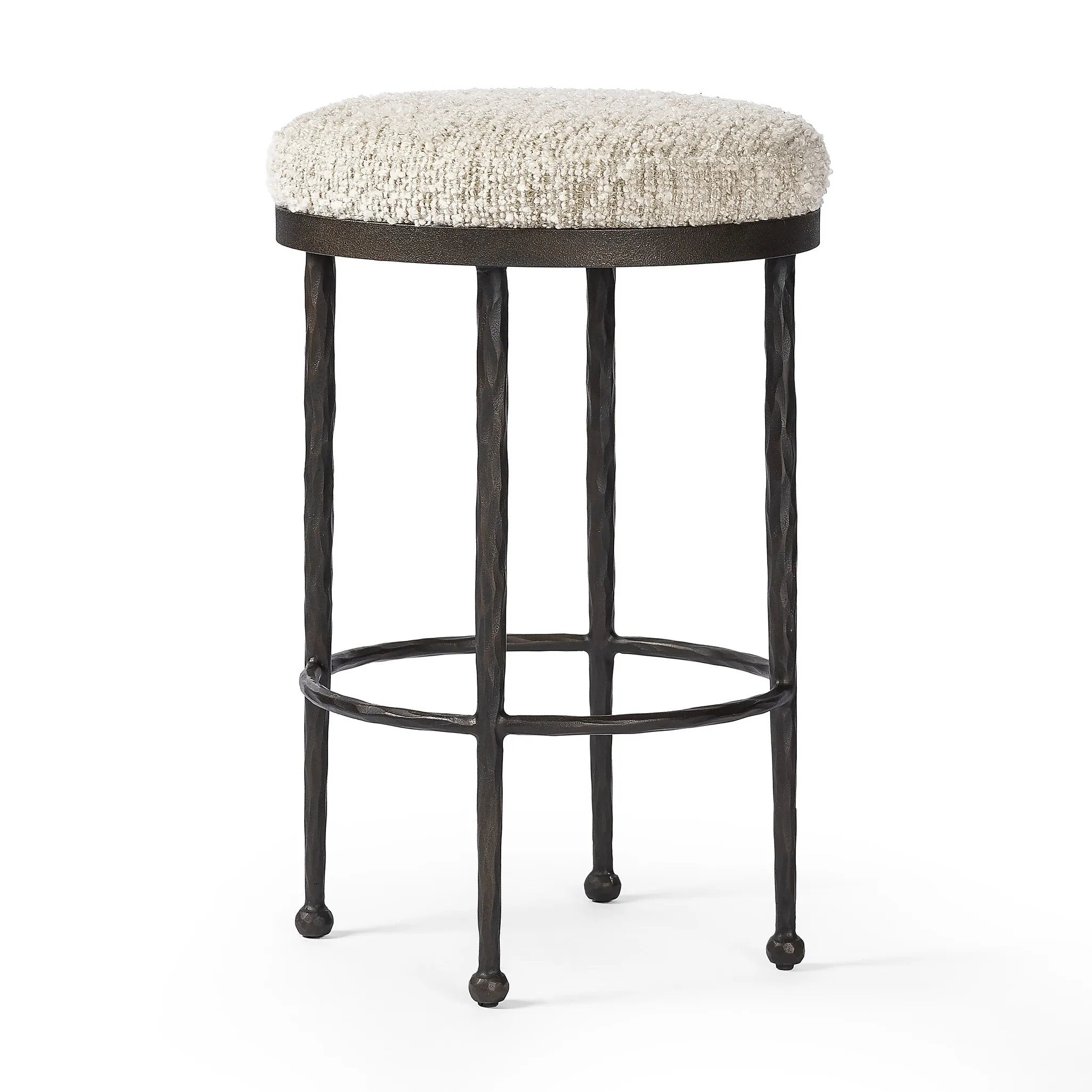 Hammered bronze legs with ball-shaped foot details elevate this simply shaped counter stool. A round, cushioned seat in a heavy boucle-like fabric finishes this counter-height stool's clean, inviting look Amethyst Home provides interior design, new home construction design consulting, vintage area rugs, and lighting in the Seattle metro area.
