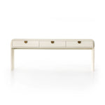 Talk about novelty. Made from painted linen in a light ivory, arched legs soften otherwise clean, modern shaping. Three drawers bring bonus storage space to the living or media room, while half-moon iron hardware adds a hint of art deco style Amethyst Home provides interior design, new home construction design consulting, vintage area rugs, and lighting in the Boston metro area.