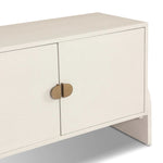 Talk about novelty. Made from painted linen in a light ivory, arched legs soften otherwise clean, modern shaping. Finished in an antique brass, half-moon iron hardware completes this media storage look. Dual rear cutouts for cord management Amethyst Home provides interior design, new home construction design consulting, vintage area rugs, and lighting in the Charlotte metro area.