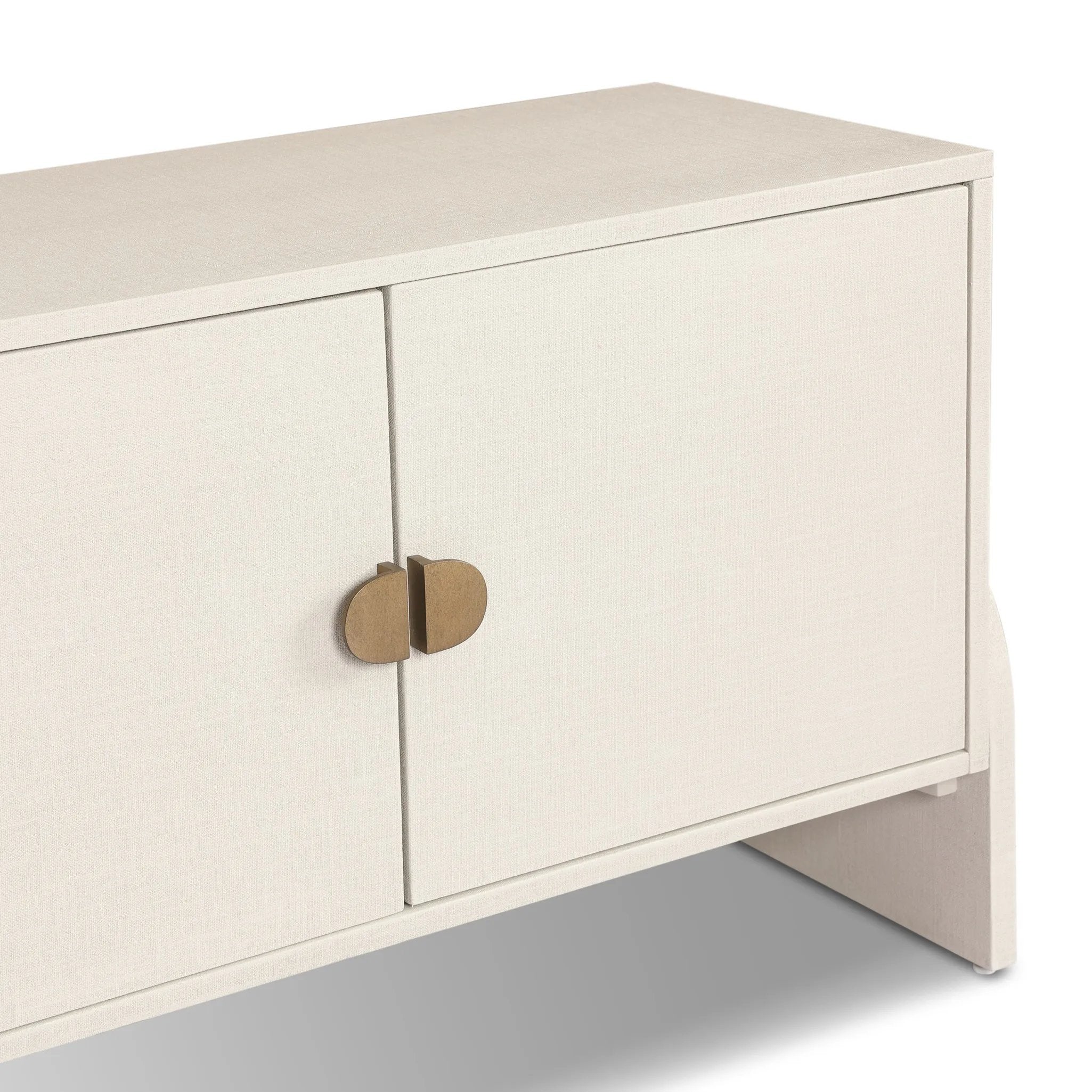 Talk about novelty. Made from painted linen in a light ivory, arched legs soften otherwise clean, modern shaping. Finished in an antique brass, half-moon iron hardware completes this media storage look. Dual rear cutouts for cord management Amethyst Home provides interior design, new home construction design consulting, vintage area rugs, and lighting in the Charlotte metro area.