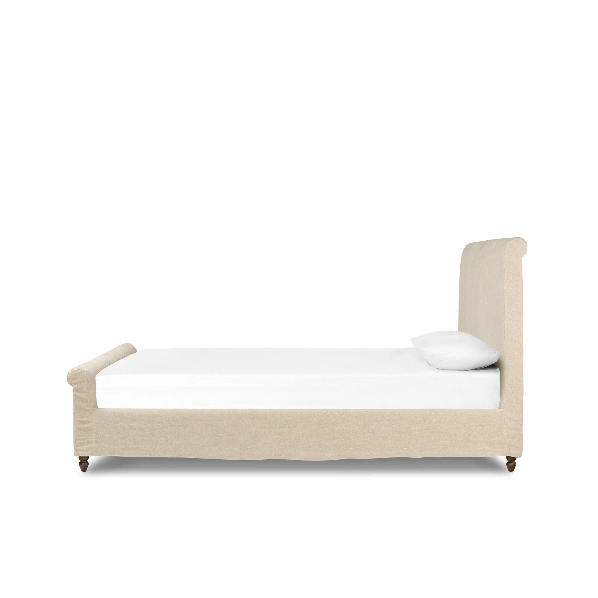 This heritage-style bed reimagines the classic sleigh silhouette. Cream-colored, linen-like fabric slipcover is both removable and washable for practicality. Turned feet in brown parawood peek from under the slip, grounding the bed's stately charm. A design collaboration by Amber Lewis and Four Hands. Amethyst Home provides interior design, new home construction design consulting, vintage area rugs, and lighting in the Tampa metro area.