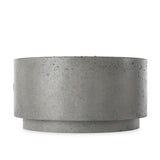 This outdoor fire table is a welcoming centerpiece designed for gathering. Made from glass-reinforced concrete, each piece is naturally finished with deep tones of pewter and dark grey. The monolithic shape is completed with lavastones in the center, bringing together a bold, monochromatic look. Amethyst Home provides interior design, new home construction design consulting, vintage area rugs, and lighting in the Salt Lake City metro area.