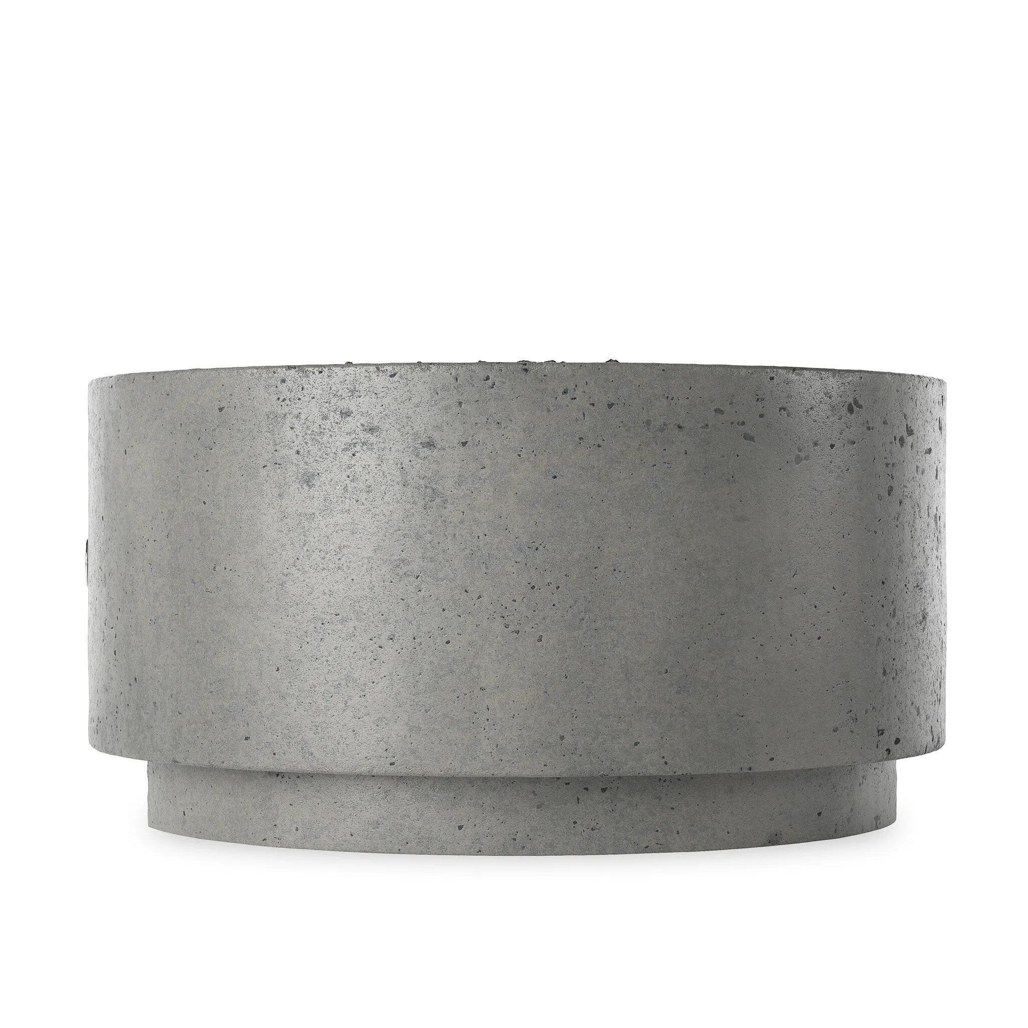 This outdoor fire table is a welcoming centerpiece designed for gathering. Made from glass-reinforced concrete, each piece is naturally finished with deep tones of pewter and dark grey. The monolithic shape is completed with lavastones in the center, bringing together a bold, monochromatic look. Amethyst Home provides interior design, new home construction design consulting, vintage area rugs, and lighting in the Salt Lake City metro area.