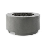 This outdoor fire table is a welcoming centerpiece designed for gathering. Made from glass-reinforced concrete, each piece is naturally finished with deep tones of pewter and dark grey. The monolithic shape is completed with lavastones in the center, bringing together a bold, monochromatic look. Amethyst Home provides interior design, new home construction design consulting, vintage area rugs, and lighting in the Tampa metro area.