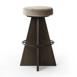 Featuring Damon Sapphire Khaki  Swivel Bar + Counter Stool by Four Hands at Amethyst Home. Large angular panels merge to form a geometrically inspired base in this modern counter stool. The circle metal ring around the base serves as a footrest, while the round upholstered cushion provides comfortable seating. The 360-degree swivel function adds versatility, a. Amethyst Home provides interior design, new home construction design consulting, vintage area rugs, and lighting in the Austin metro area.