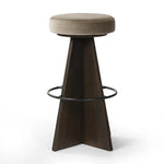 Featuring Damon Sapphire Khaki  Swivel Bar + Counter Stool by Four Hands at Amethyst Home. Large angular panels merge to form a geometrically inspired base in this modern counter stool. The circle metal ring around the base serves as a footrest, while the round upholstered cushion provides comfortable seating. The 360-degree swivel function adds versatility, a. Amethyst Home provides interior design, new home construction design consulting, vintage area rugs, and lighting in the Boston metro area.