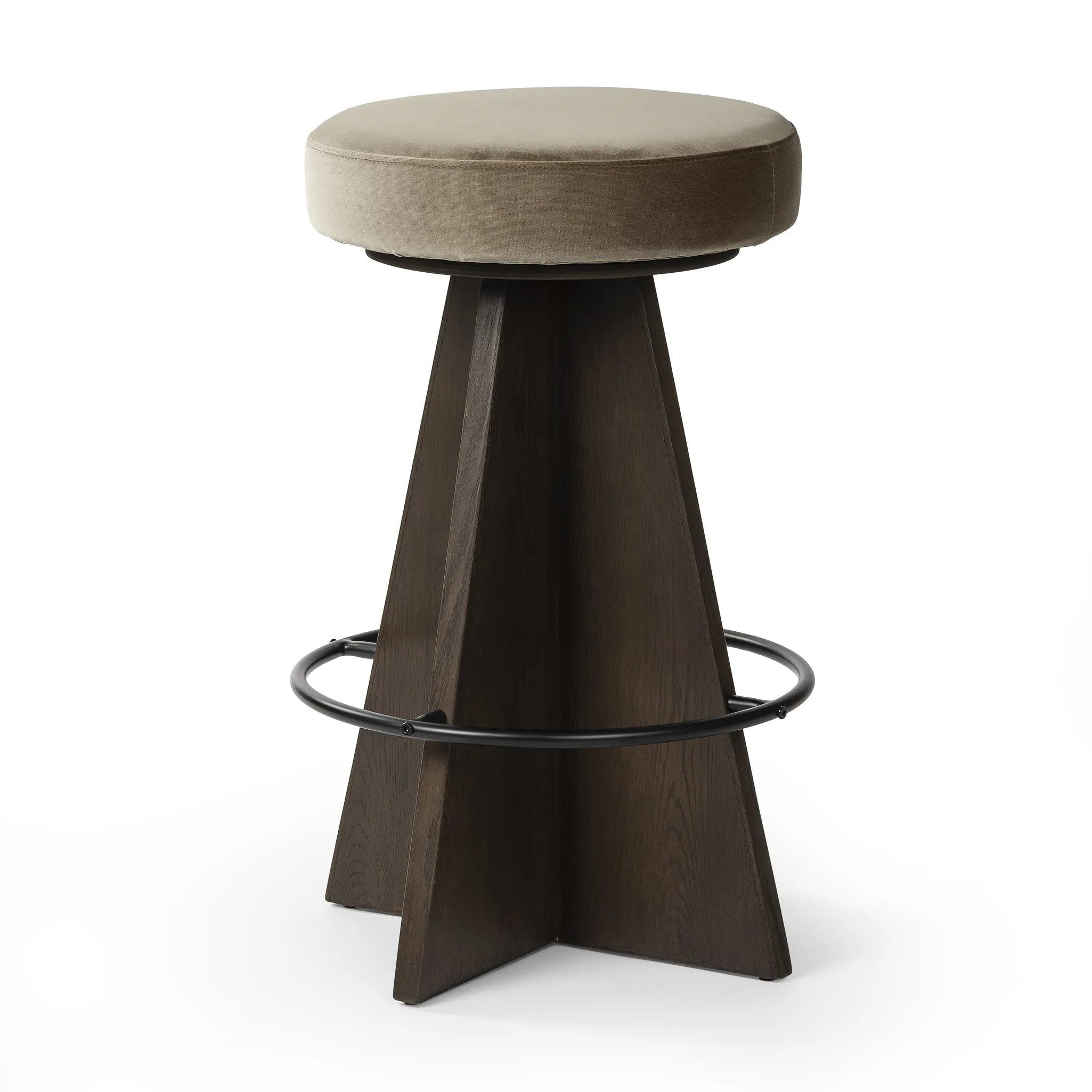 Large angular panels merge to form a geometrically inspired base in this modern counter stool. The circle metal ring around the base serves as a footrest, while the round upholstered cushion provides comfortable seating. The 360-degree swivel function adds versatility, and the combination of wood, metal, and fabric evoke a mixed material moment Amethyst Home provides interior design, new home construction design consulting, vintage area rugs, and lighting in the Seattle metro area.