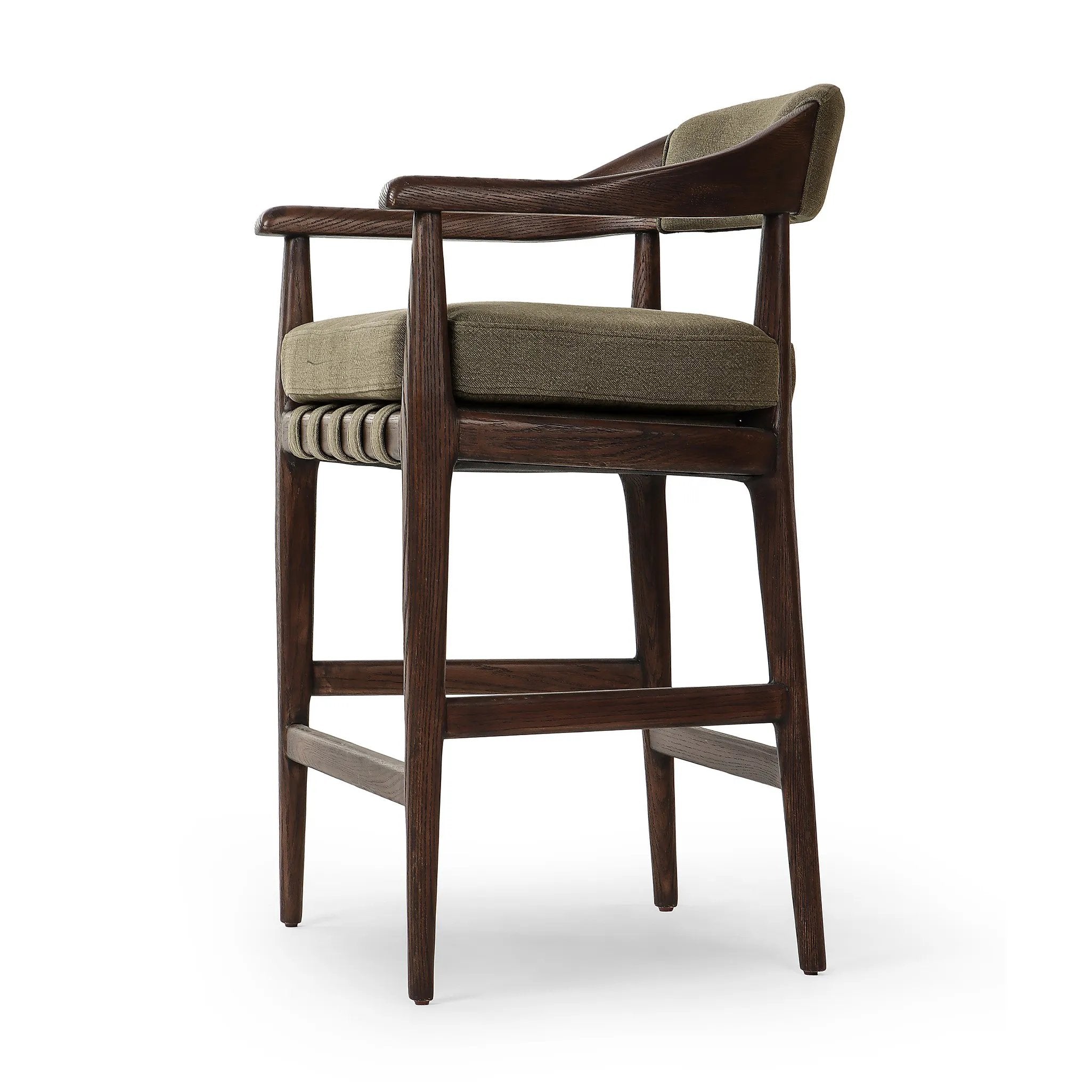 Featuring Dane Broadway Olive Stool by Four Hands at Amethyst Home. Traditional safari styling is brought to modern speed. A solid wood frame features a webbed seating structure that brings a supported, sink-in feel to the entire piece. The upholstered back, strap details and loose cushion are finished in an olive flax/linen-blend fabric. Perfectly sized for t. Amethyst Home provides interior design, new home construction design consulting, vintage area rugs, and lighting in the Boston metro area.